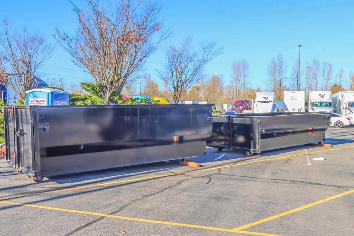 Professional dumpster rental service with roll-off container on residential driveway in Pearland